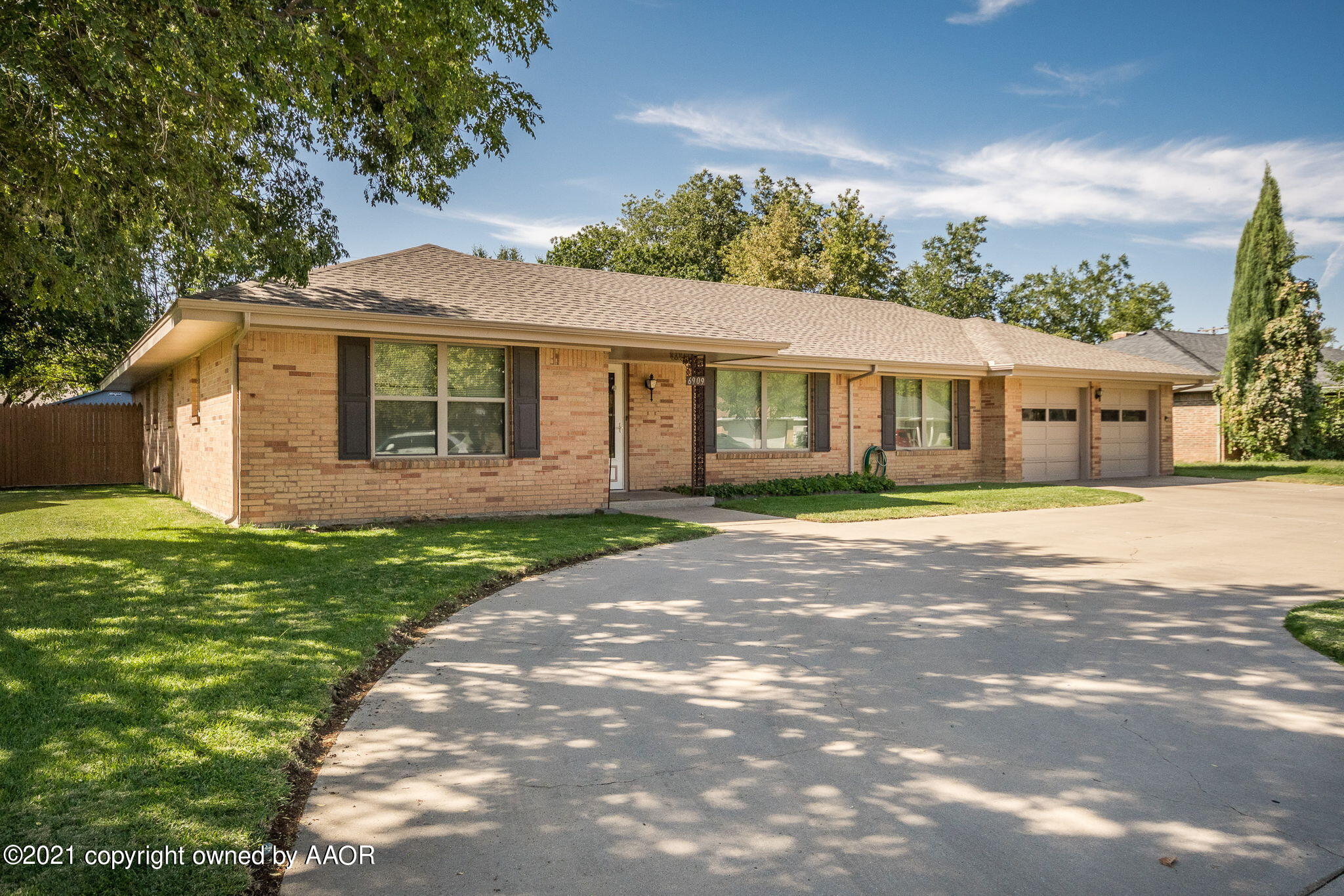 6909 Elmhurst Road Amarillo, TX 79106 - Photo 1 of 23 a front view of a house with a garden