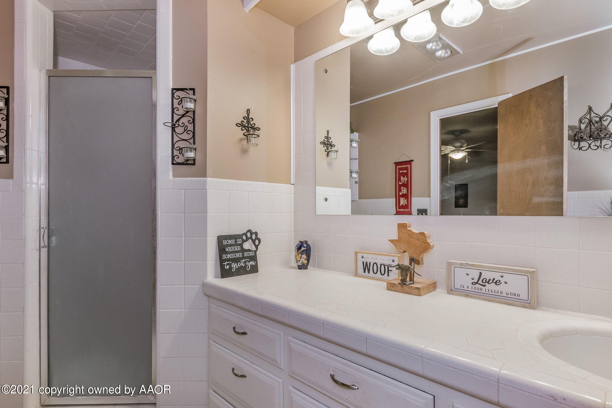 6909 Elmhurst Road Amarillo, TX 79106 - Photo 15 of 23 a bathroom with a sink a large mirror and vanity