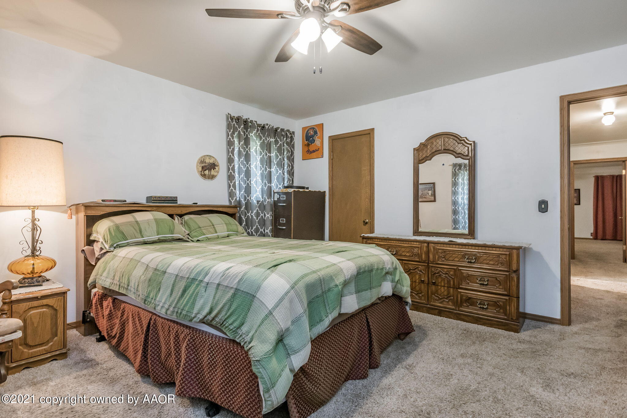 6909 Elmhurst Road Amarillo, TX 79106 - Photo 17 of 23 a bedroom with a bed and a chandelier