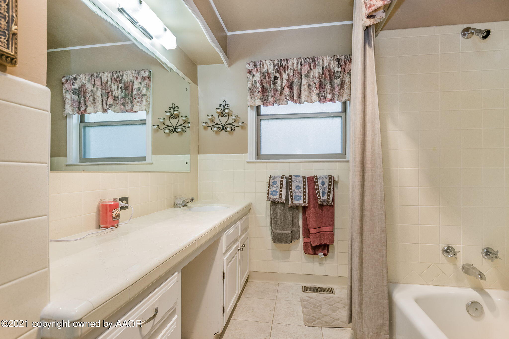 6909 Elmhurst Road Amarillo, TX 79106 - Photo 18 of 23 a bathroom with a sink and a mirror