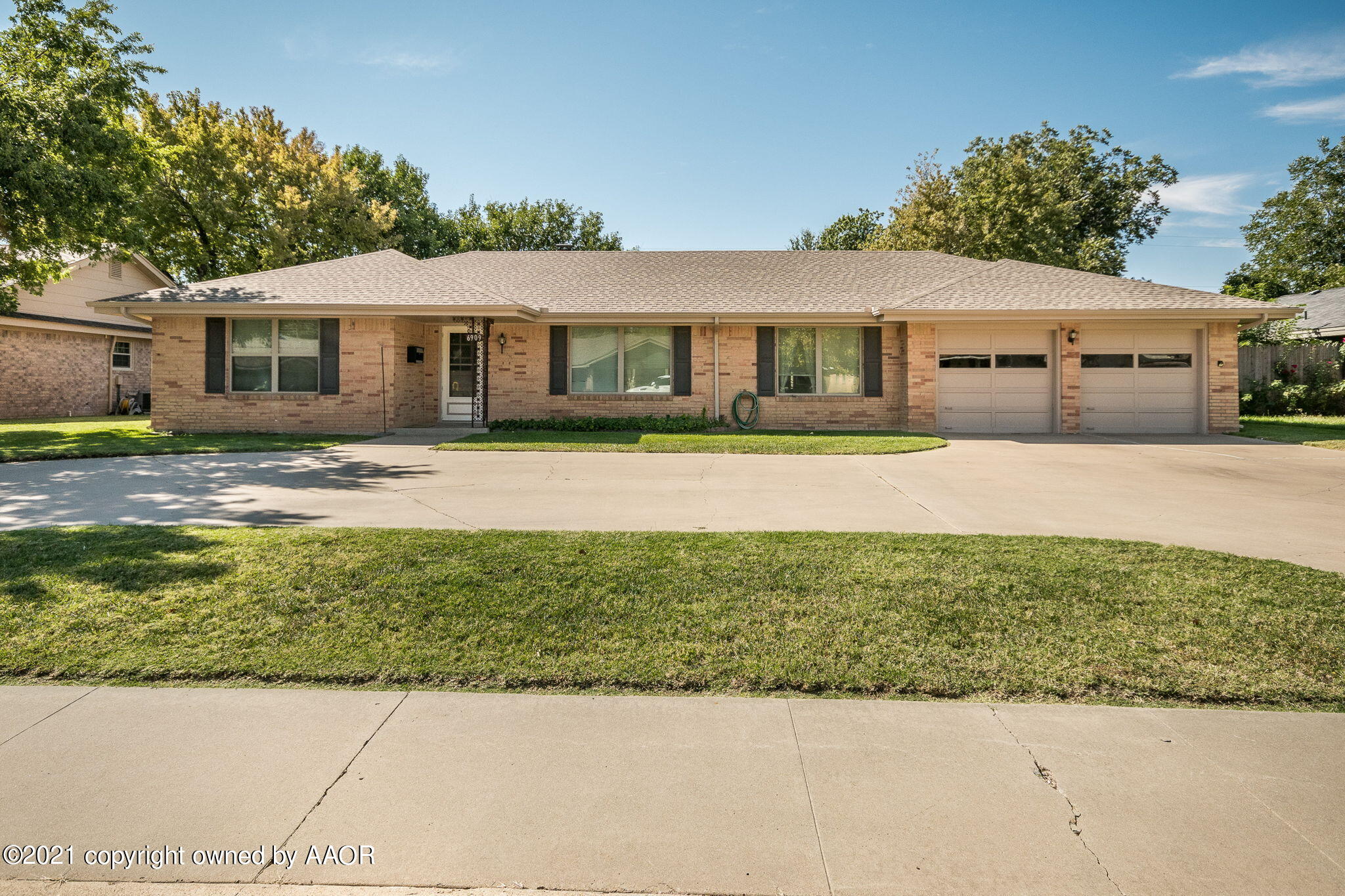 6909 Elmhurst Road Amarillo, TX 79106 - Photo 23 of 23 a front view of a house with a garden and yard