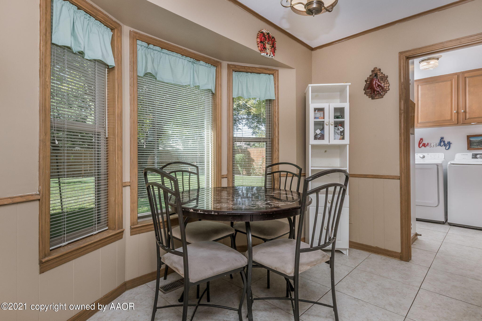 6909 Elmhurst Road Amarillo, TX 79106 - Photo 8 of 23 a view of a dining room with furniture and window