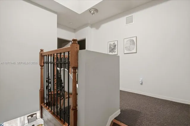 a view of a hallway with stairs