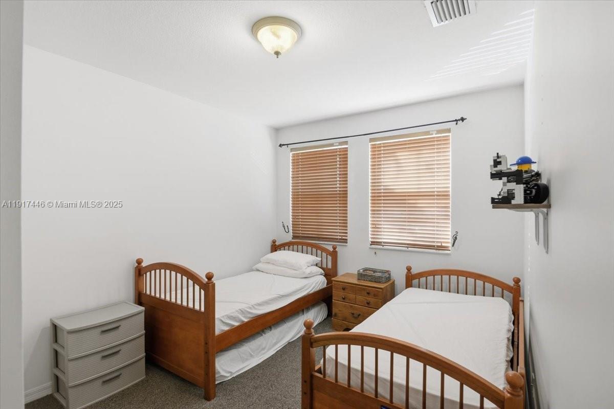 10891 Southwest 88th Terrace Miami, FL 33176 - Photo 19 of 41 a bedroom with furniture and a window