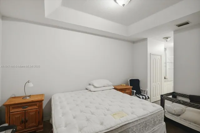 a bedroom with a bed and a desk