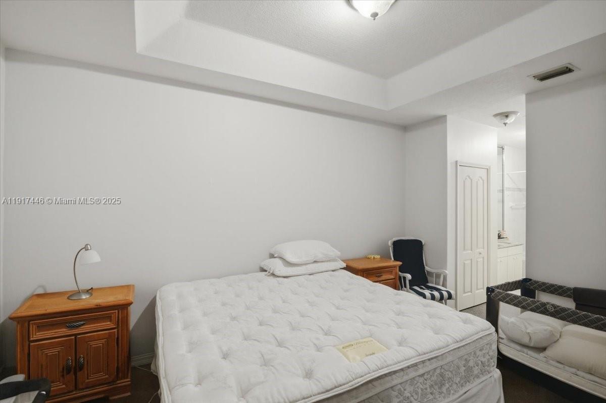 10891 Southwest 88th Terrace Miami, FL 33176 - Photo 24 of 41 a bedroom with a bed and a desk