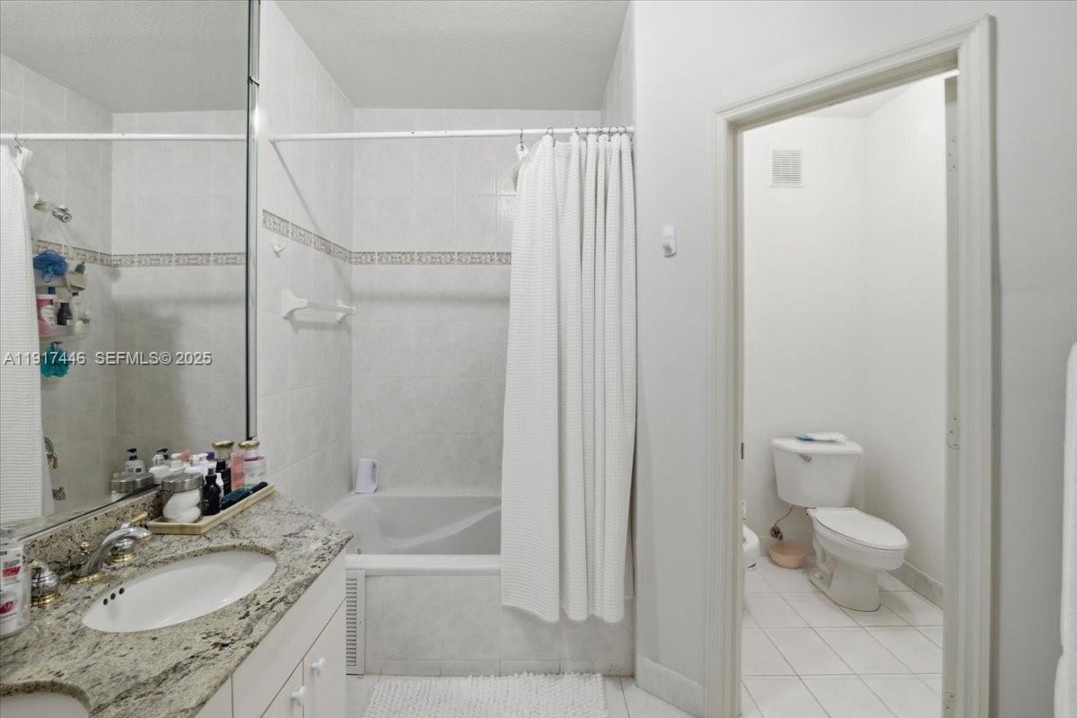 10891 Southwest 88th Terrace Miami, FL 33176 - Photo 26 of 41 a bathroom with a granite countertop sink a toilet and shower