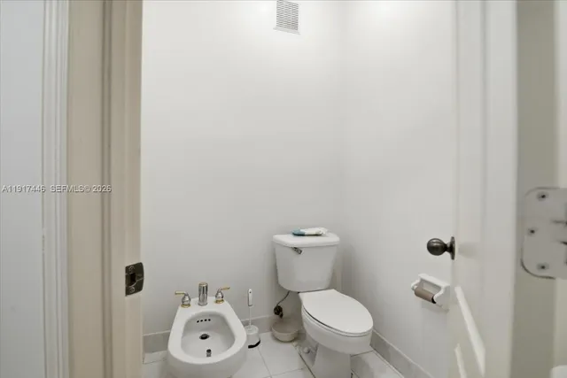 a white toilet sitting next to a bathroom sink