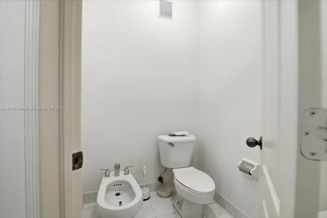a white toilet sitting next to a bathroom sink