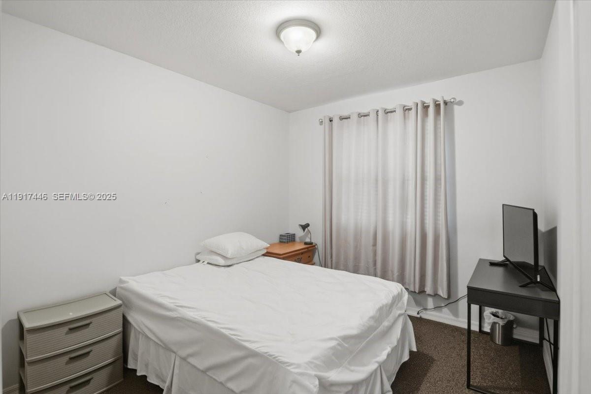 10891 Southwest 88th Terrace Miami, FL 33176 - Photo 28 of 41 a bedroom with a bed and a window