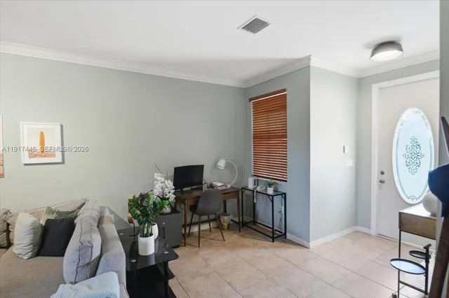 a view of a livingroom with a couch and a potted plant