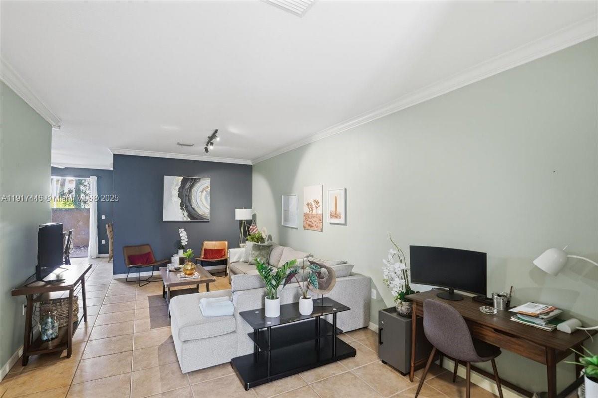 10891 Southwest 88th Terrace Miami, FL 33176 - Photo 8 of 41 a living room with furniture and a flat screen tv