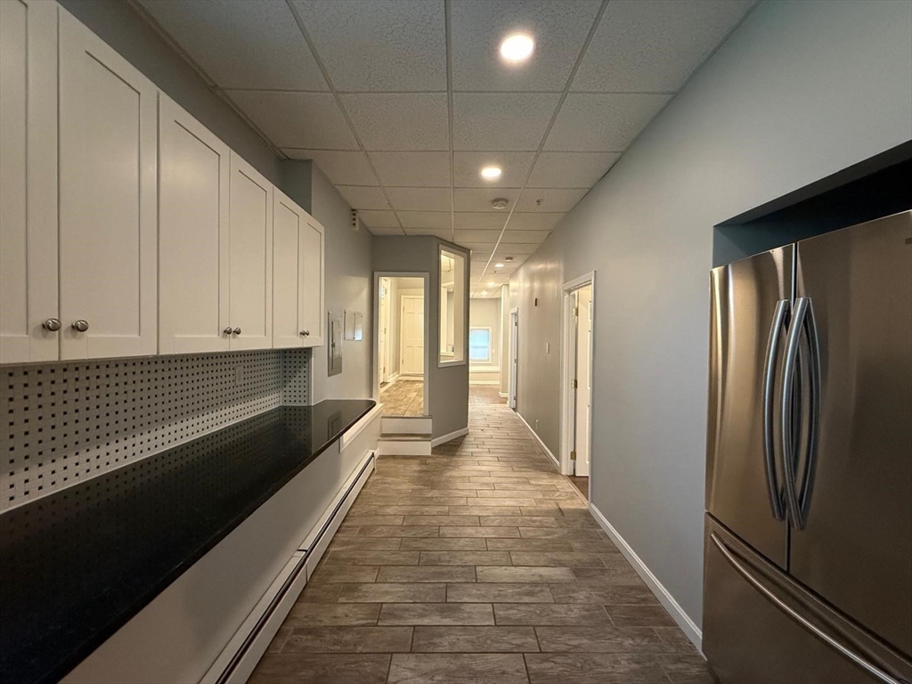 690 Lawrence Street, Unit 1 Lowell, MA 01852 - Photo 3 of 8 a view of a refrigerator in the kitchen