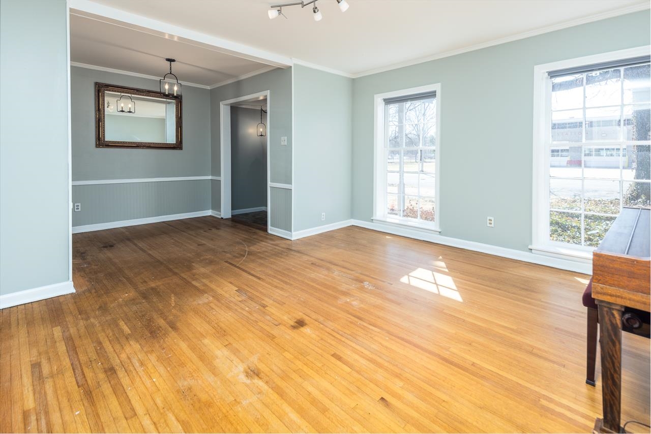 4734 Willow Road Memphis, TN 38117 - Photo 3 of 23 a view of an empty room with wooden floor and a window