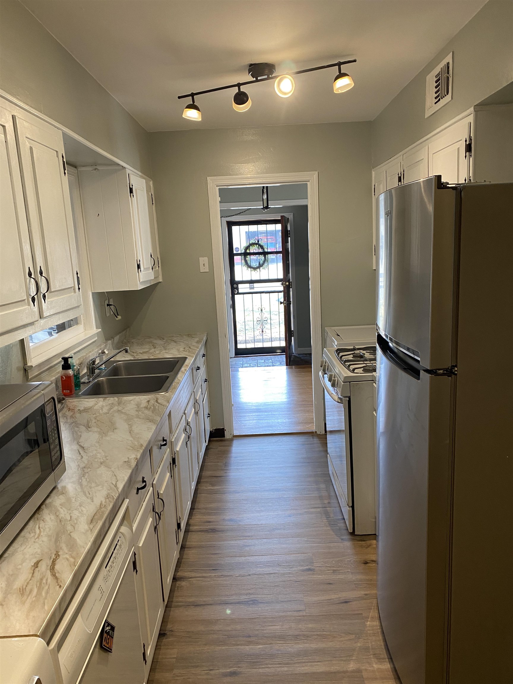 4734 Willow Road Memphis, TN 38117 - Photo 8 of 23 a kitchen with sink a refrigerator and wooden floor