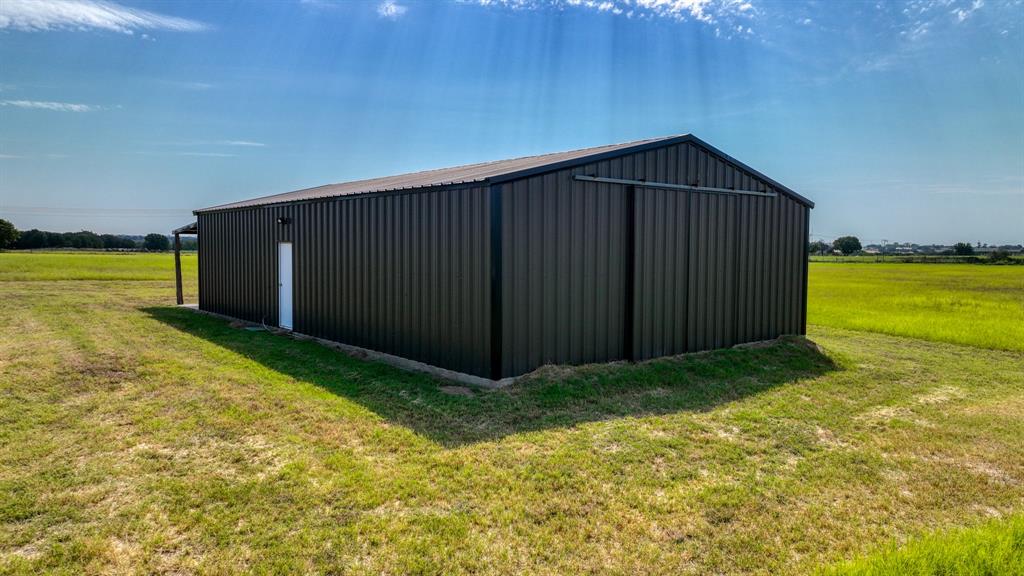 3810 Fairview Road Millsap, TX 76066 - Photo 20 of 25 View of pole building with a lawn and a view of rural / pastoral area