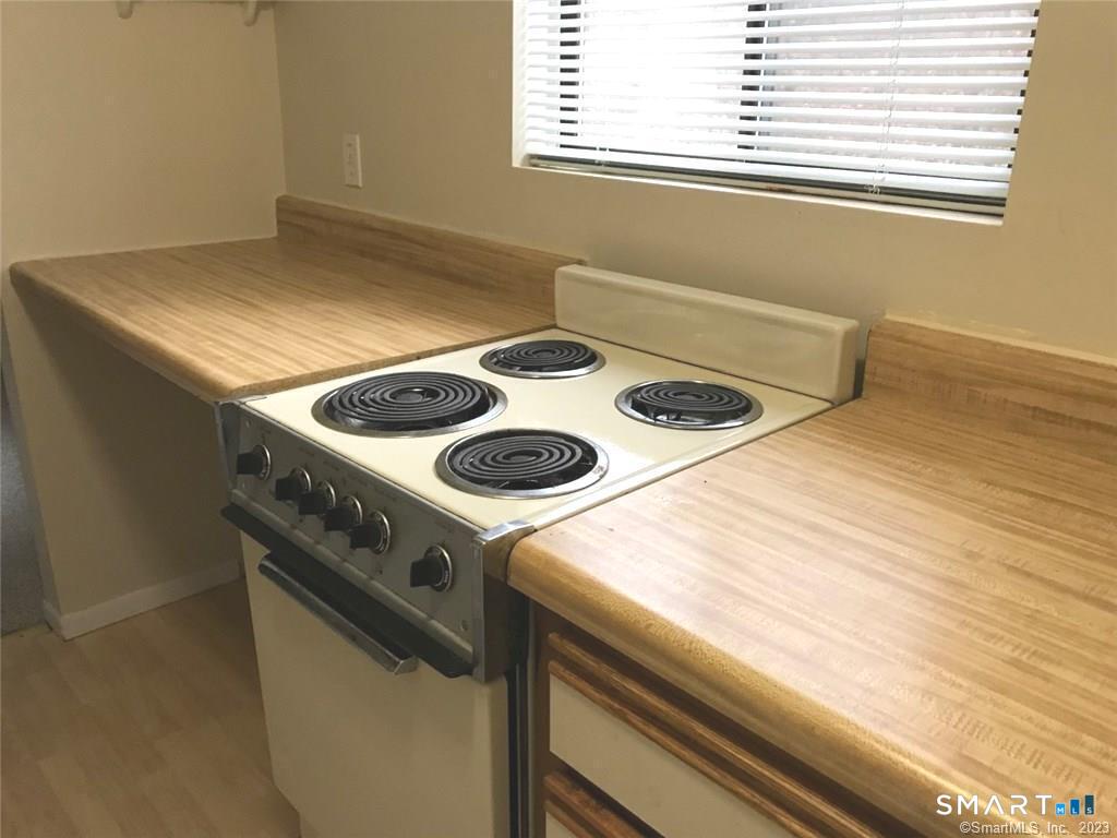 5 Nabby Road, Unit A51 Danbury, CT 06811 - Photo 6 of 13 a stove top oven sitting inside of a kitchen