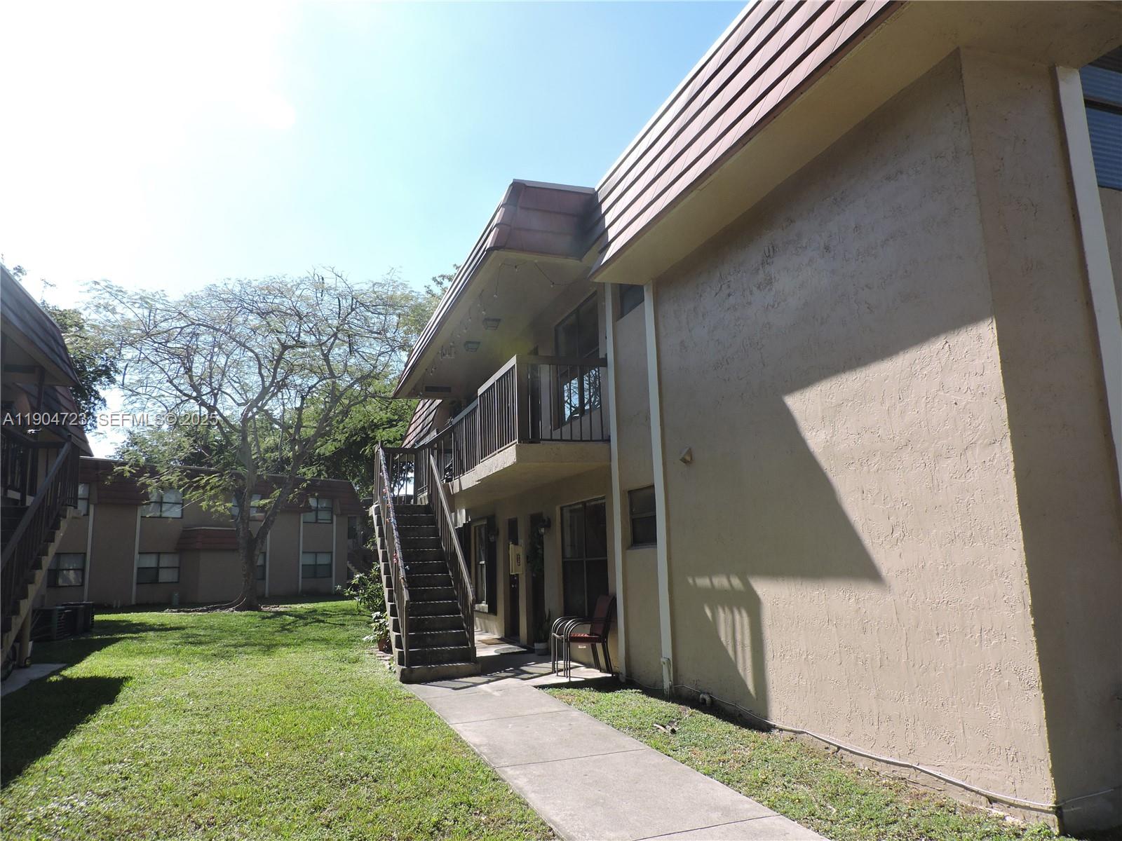 14867 Southwest 104th Street, Unit 2421 Miami, FL 33196 - Photo 1 of 18 a front view of a house with garden