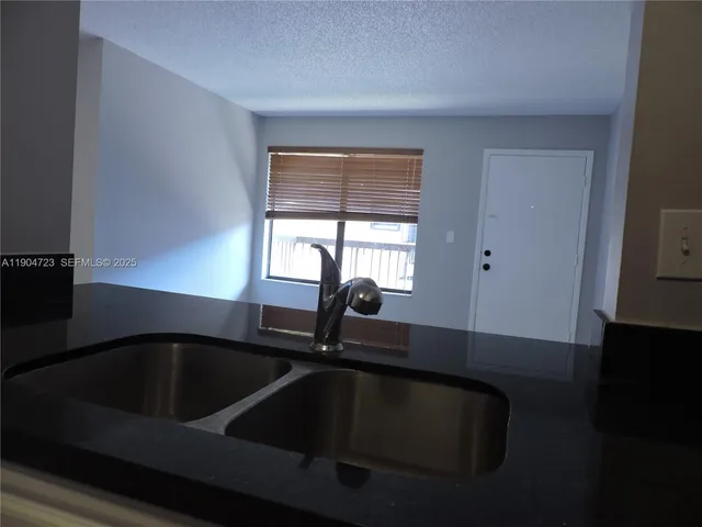 a kitchen with a sink and a window