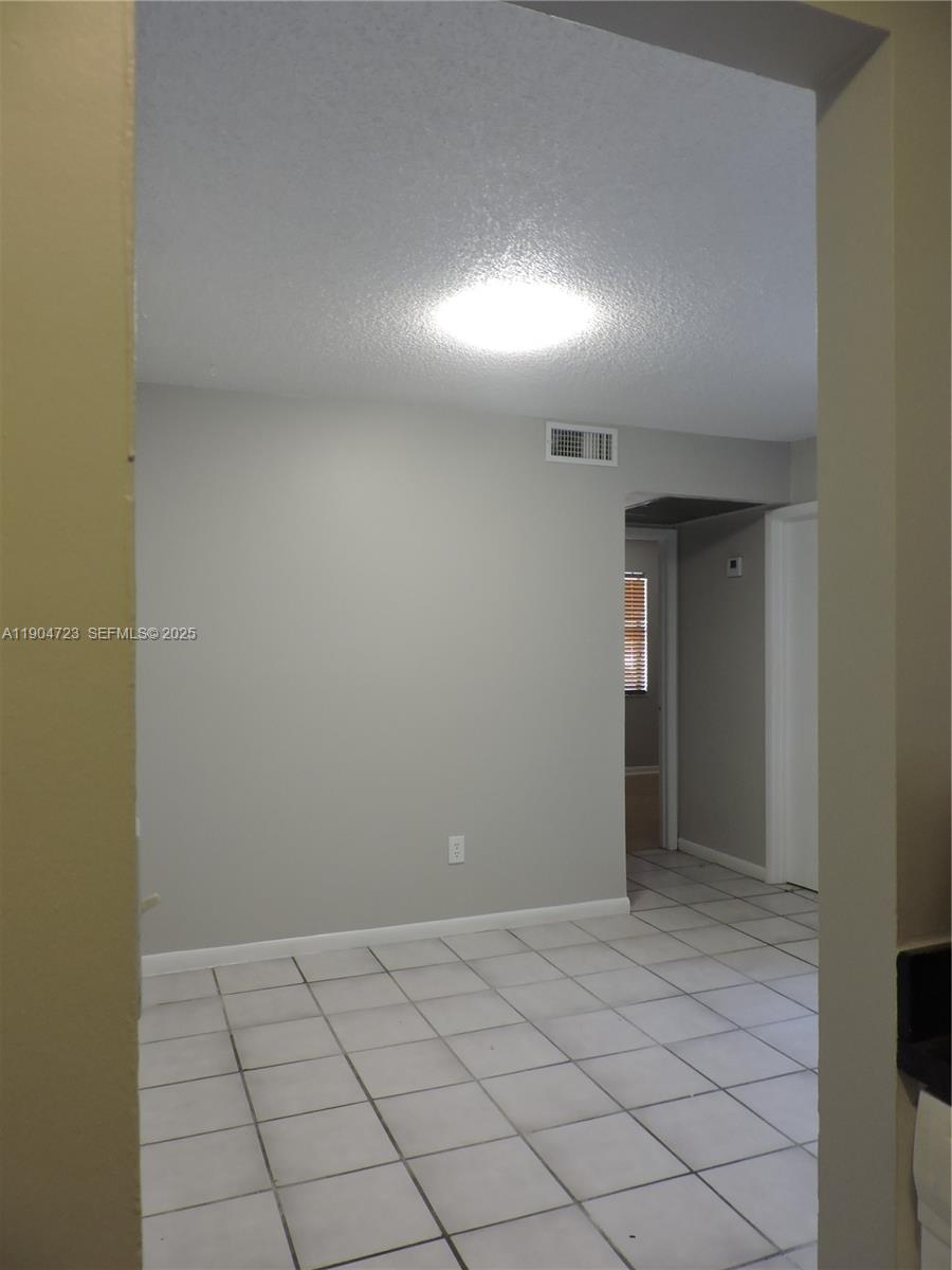 14867 Southwest 104th Street, Unit 2421 Miami, FL 33196 - Photo 5 of 18 a view of an empty room