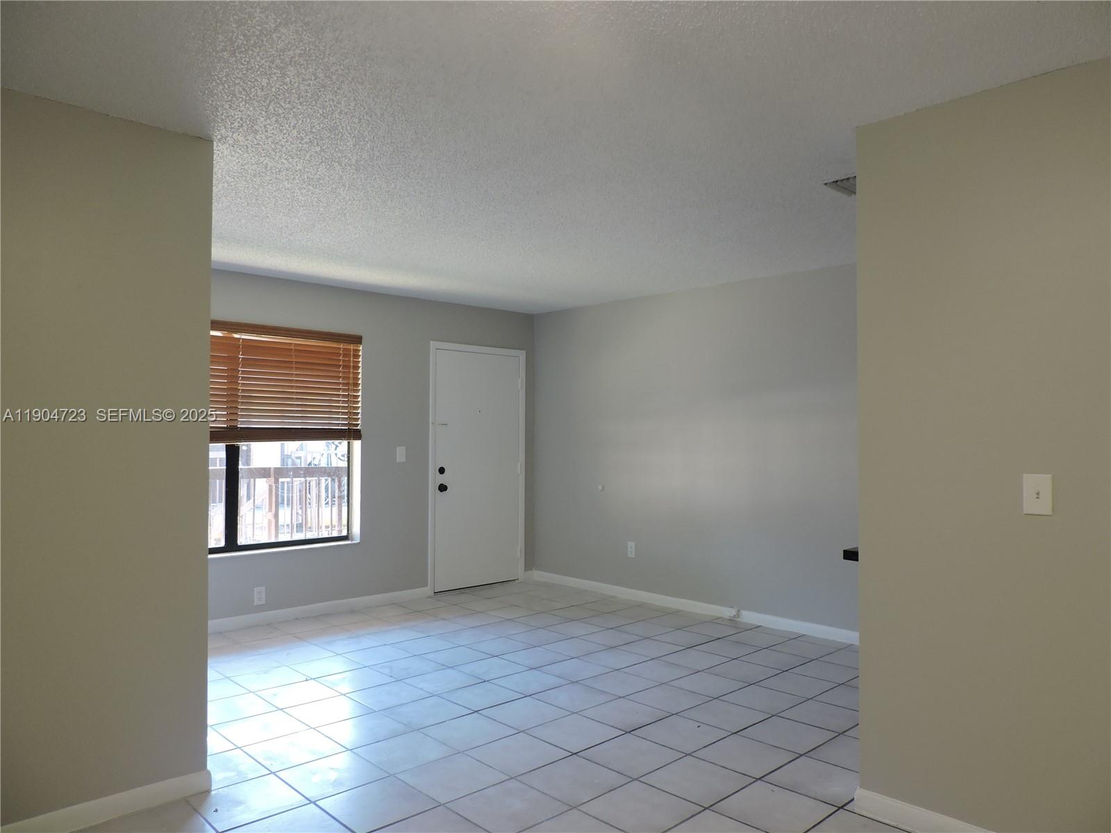 14867 Southwest 104th Street, Unit 2421 Miami, FL 33196 - Photo 6 of 18 a view of an empty room and window