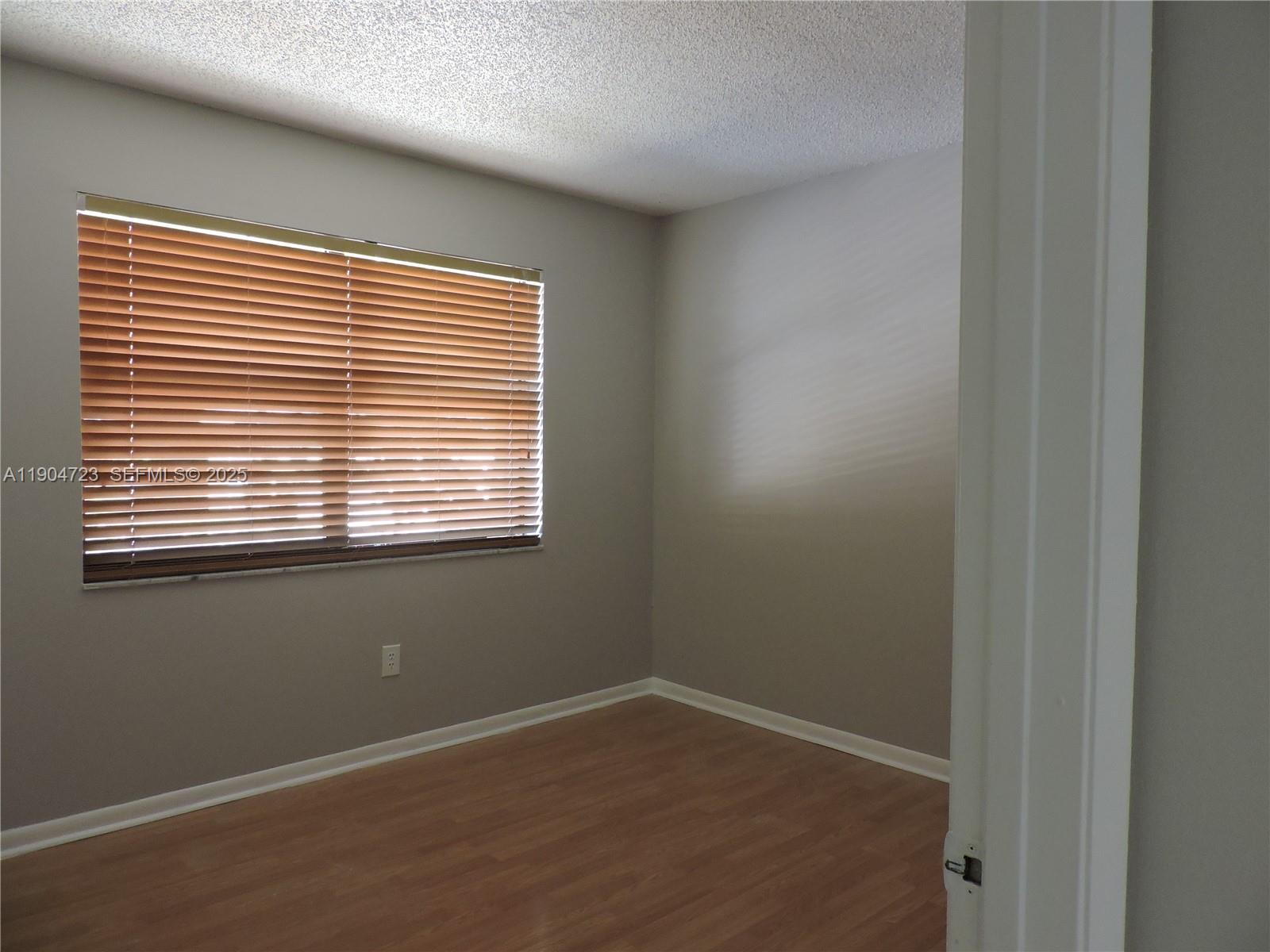 14867 Southwest 104th Street, Unit 2421 Miami, FL 33196 - Photo 9 of 18 an empty room with a window