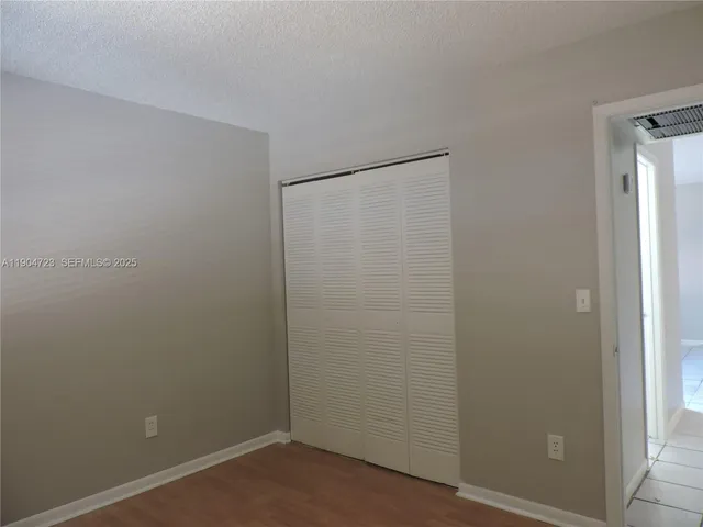 an empty room with a fan and a fan