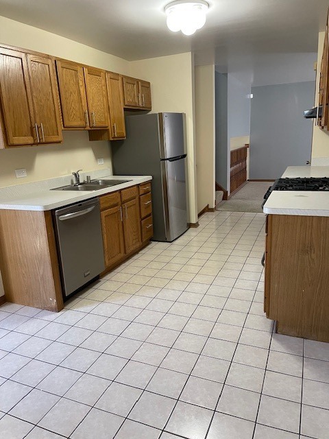 910 East 152nd Place Phoenix, IL 60426 - Photo 11 of 28 a kitchen with stainless steel appliances a sink a stove a refrigerator a microwave a sink and cabinets