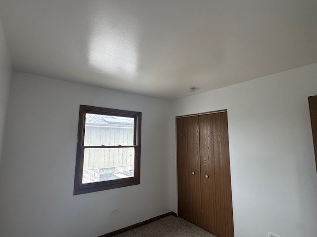 910 East 152nd Place Phoenix, IL 60426 - Photo 17 of 28 an empty room with windows and closet