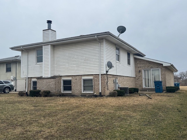 910 East 152nd Place Phoenix, IL 60426 - Photo 3 of 28 a front view of a house with a yard
