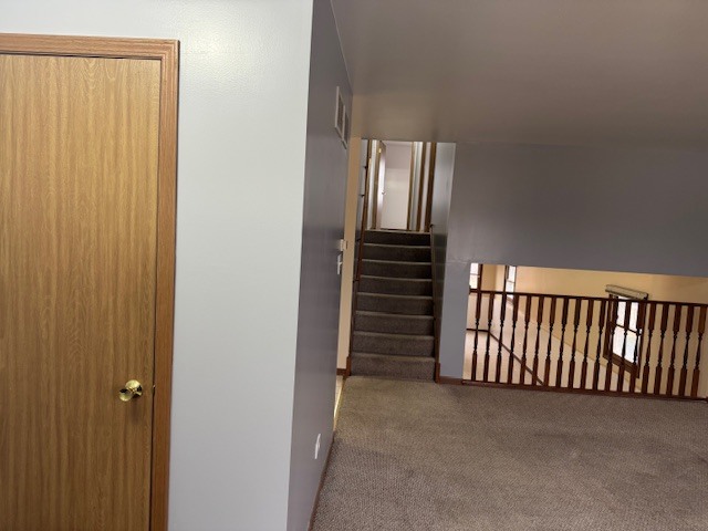 910 East 152nd Place Phoenix, IL 60426 - Photo 5 of 28 a view of a hallway with stairs and a door