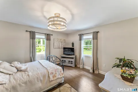 a bedroom with a bed and a chair