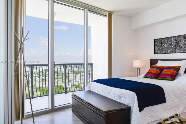 a bedroom with a large bed and a large window