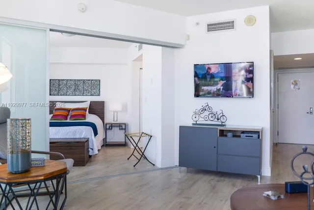 a living room with furniture fireplace and a large window