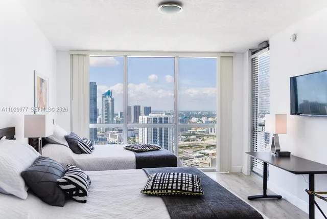 a bedroom with a bed and painting on the wall