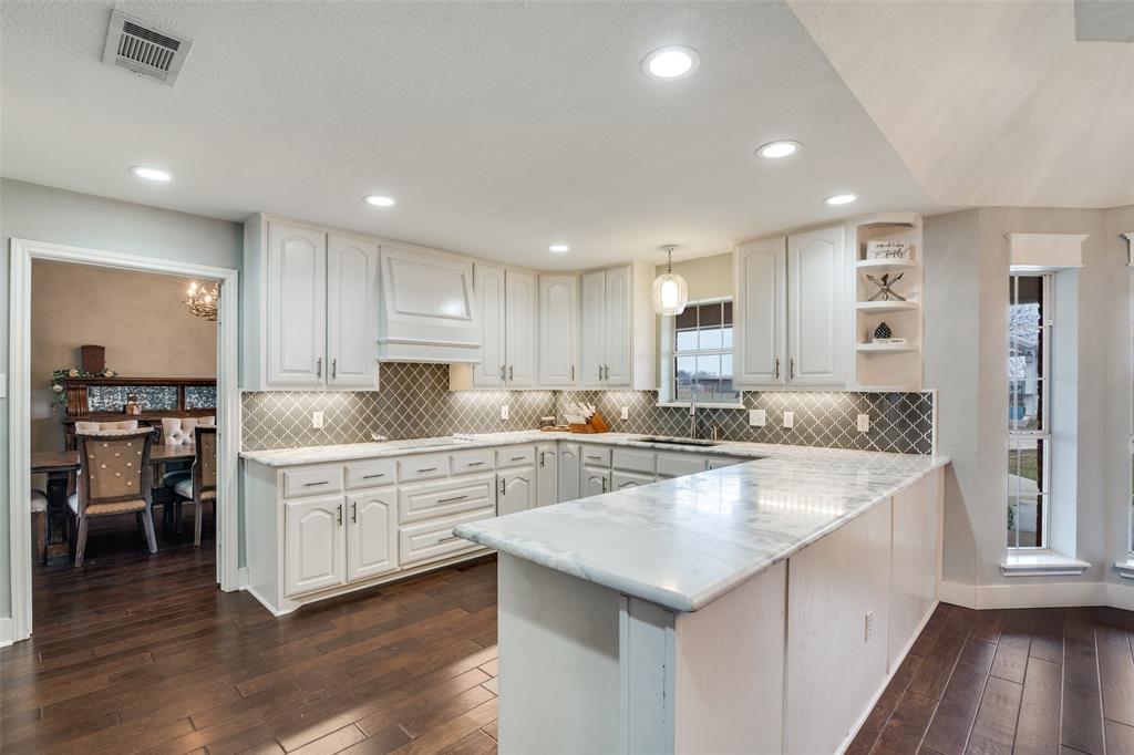 19930 County Road 324 Terrell, TX 75160 - Photo 12 of 40 a large white kitchen with lots of counter space and wooden floor
