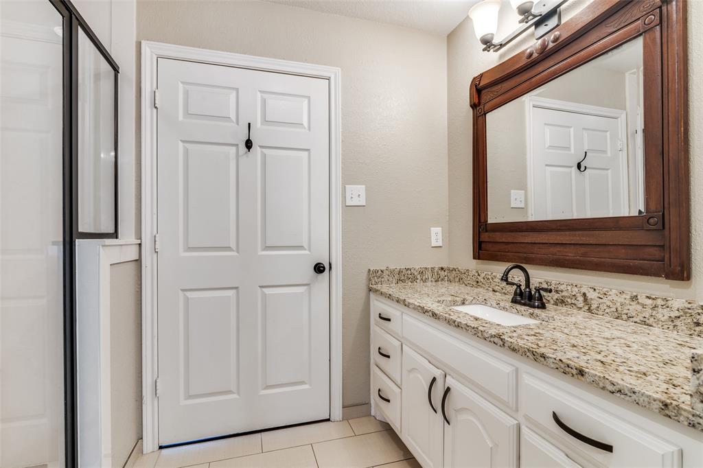 19930 County Road 324 Terrell, TX 75160 - Photo 26 of 40 a bathroom with a granite countertop sink and a mirror