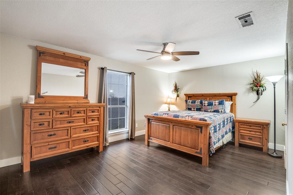 19930 County Road 324 Terrell, TX 75160 - Photo 28 of 40 a bedroom with a bed and a dresser