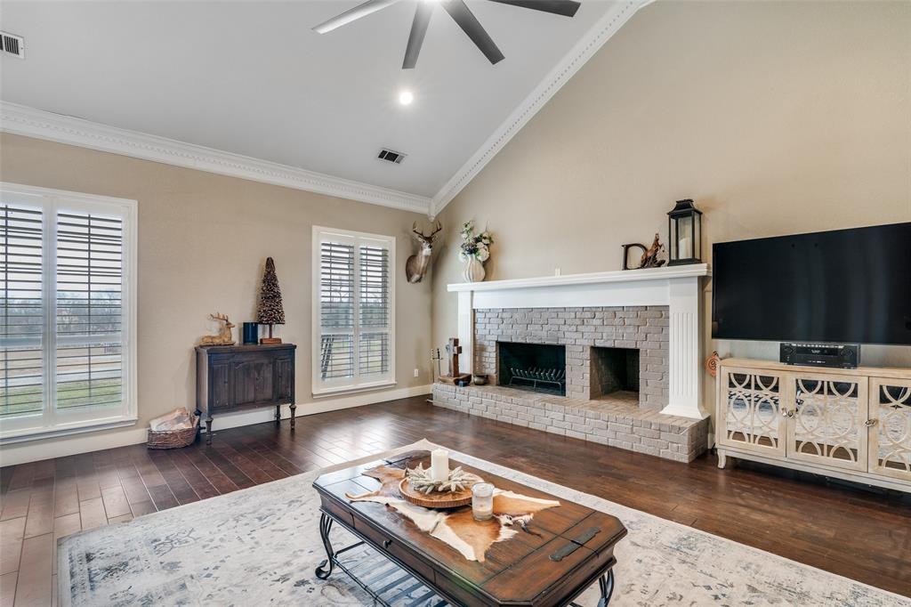 19930 County Road 324 Terrell, TX 75160 - Photo 7 of 40 a living room with furniture a flat screen tv and a fireplace