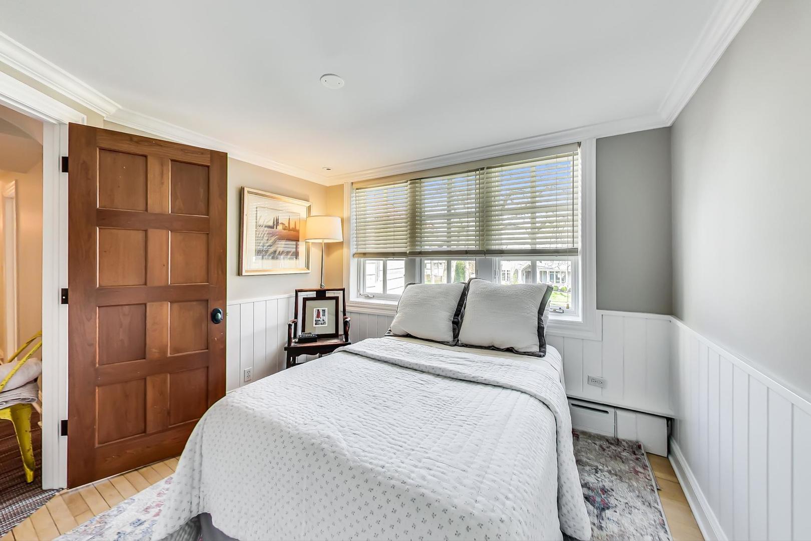 32 Crescent Place Wilmette, IL 60091 - Photo 19 of 45 a bedroom with a large bed and a window