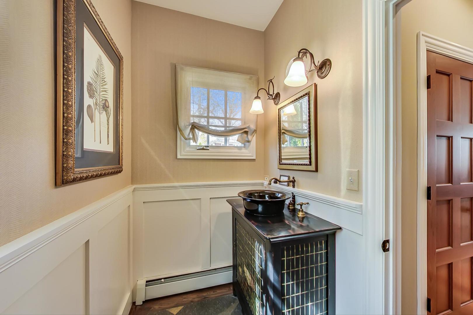 32 Crescent Place Wilmette, IL 60091 - Photo 3 of 45 a bathroom with a sink and a mirror