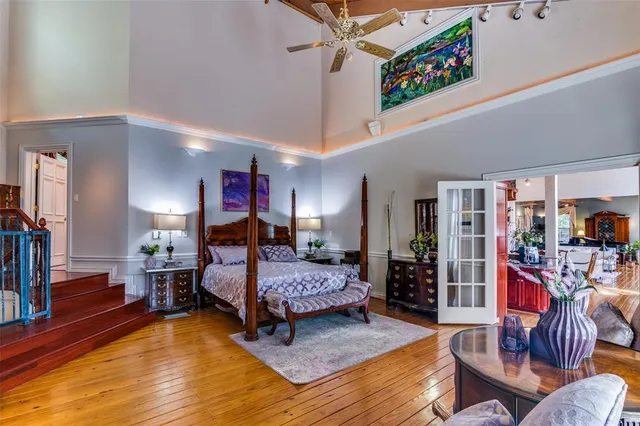 a bedroom with furniture and wooden floor