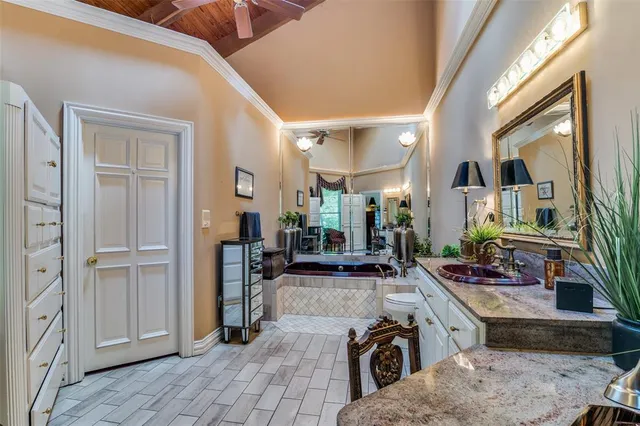 a room with lots of wooden furniture and large mirror