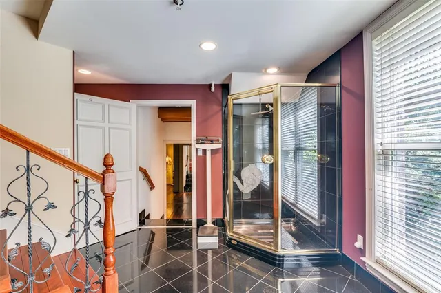 a view of a hallway with wooden floor and windows