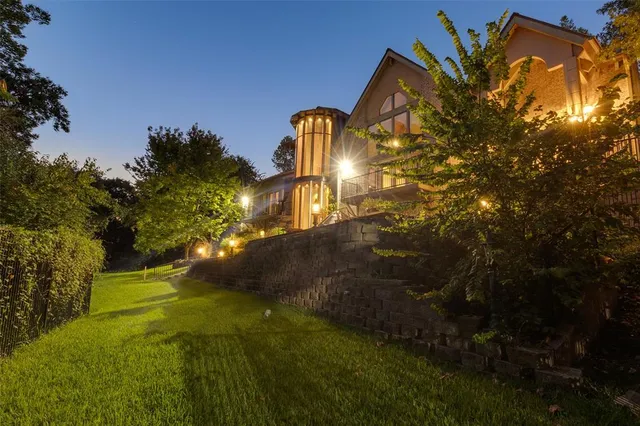 a backyard of a house with lots of green space and garden