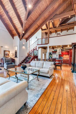 a living room with patio furniture and a rug