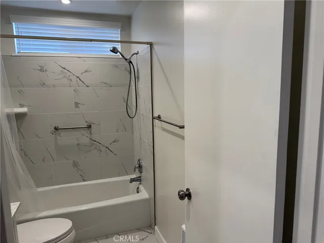 a bathroom with a shower and a toilet