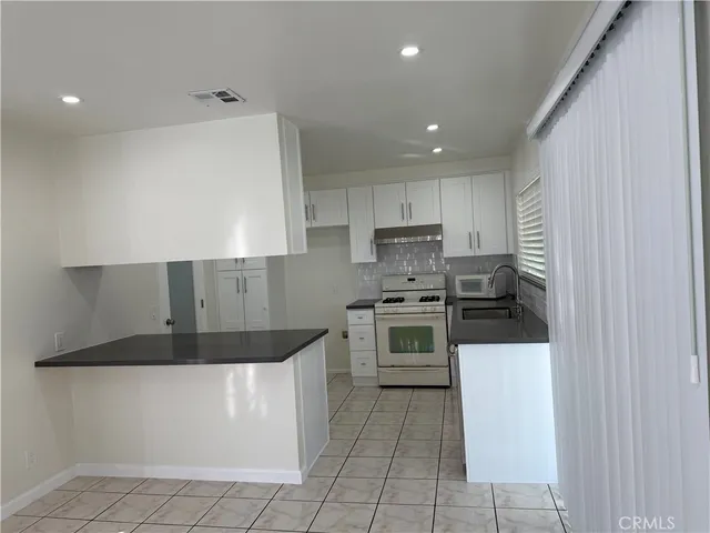 a kitchen with stainless steel appliances a refrigerator sink and stove