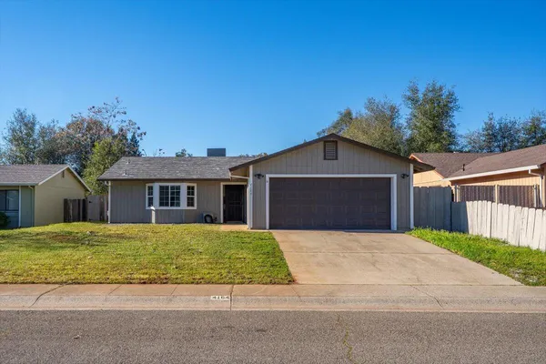 a front view of a house with yard