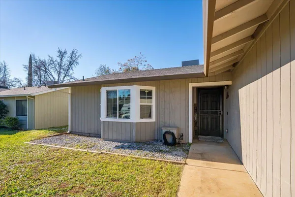 a view of house with backyard space